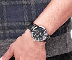 Hugo Boss chronograph watch worn on wrist with black strap and checkered shirt