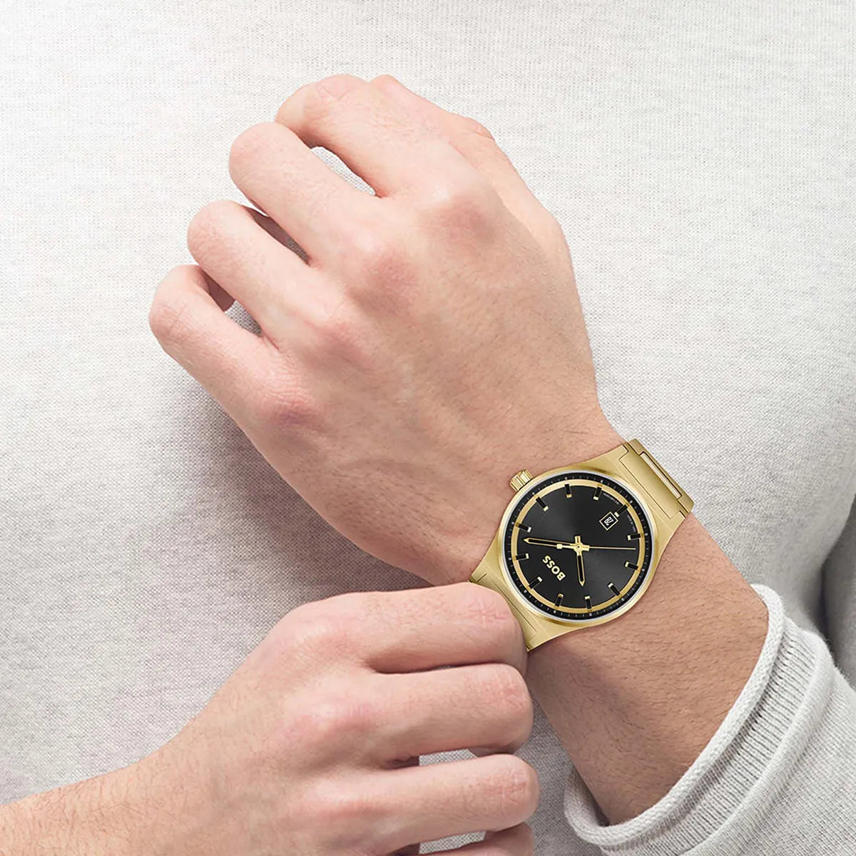 Hugo Boss Candor watch worn on wrist, displaying black dial and gold bracelet