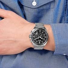 Hugo Boss Driver men's watch worn on wrist over blue shirt