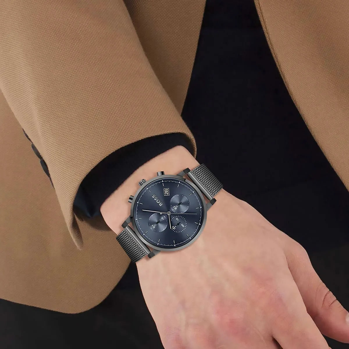 Hugo Boss Integrity watch on wrist showing grey mesh bracelet and blue chronograph dial
