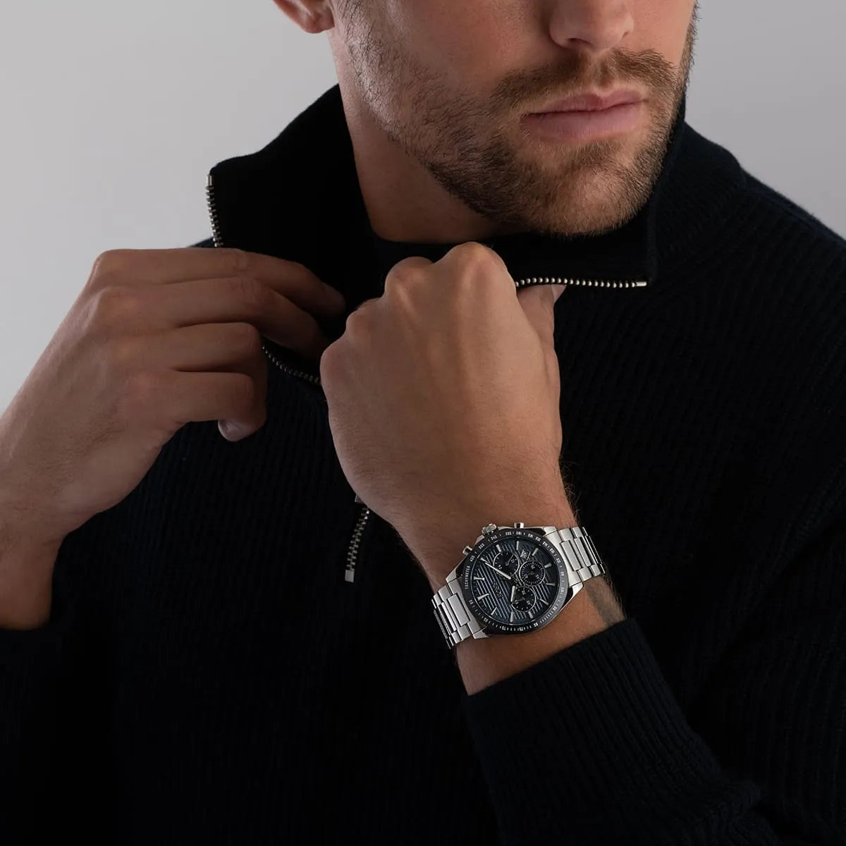 Man wearing Hugo Boss Strike chronograph watch on wrist with blue dial