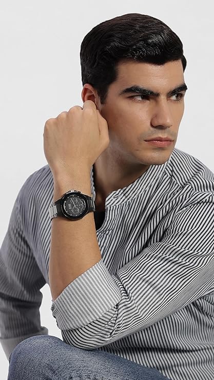 Hugo Boss Taper chronograph watch worn on wrist by man in striped shirt