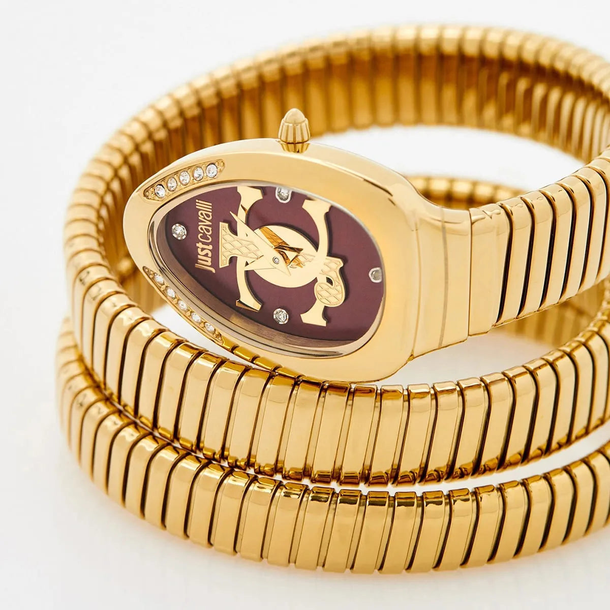 Just Cavalli Glam Evo 5 dial detail with red face, gold snake logo, and crystal-set bezel