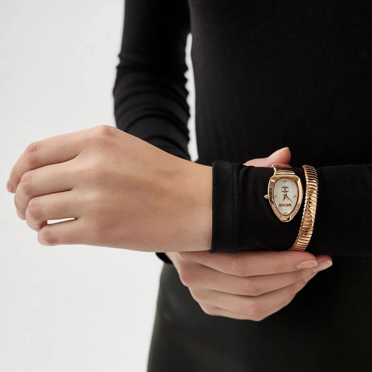 Just Cavalli Snake watch on wrist displaying rose gold case and snake-pattern stainless steel bracelet
