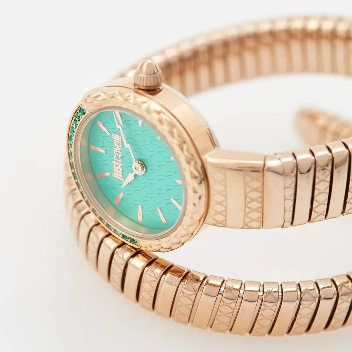 Close-up of Just Cavalli Snake dial featuring green face with rose gold case and crystal bezel