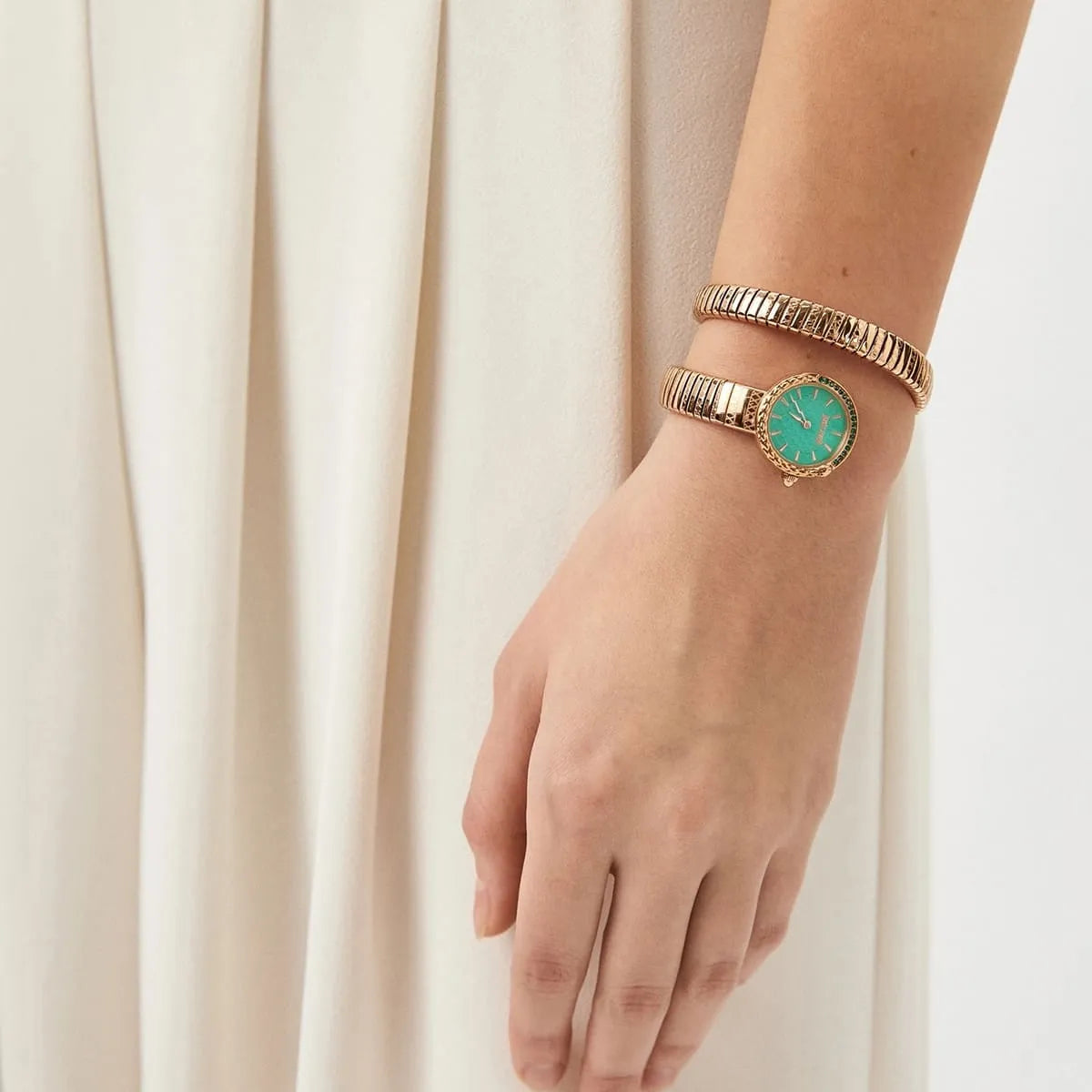 Just Cavalli Snake women's watch worn on wrist with rose gold snake bracelet and green dial