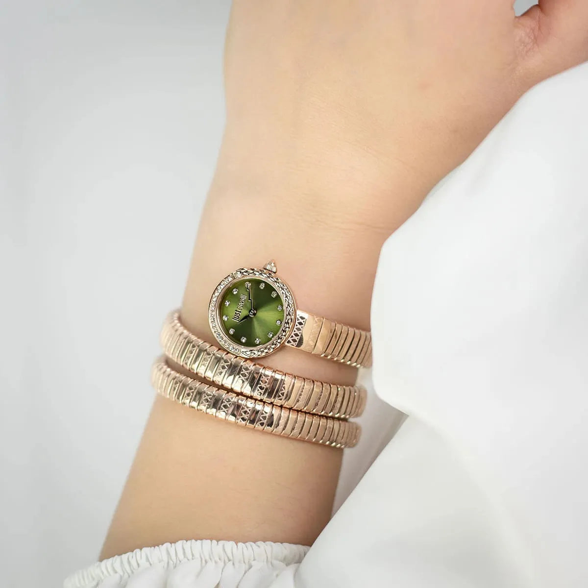 Just Cavalli Enchanting watch worn on wrist showing green dial and rose gold triple-wrap strap