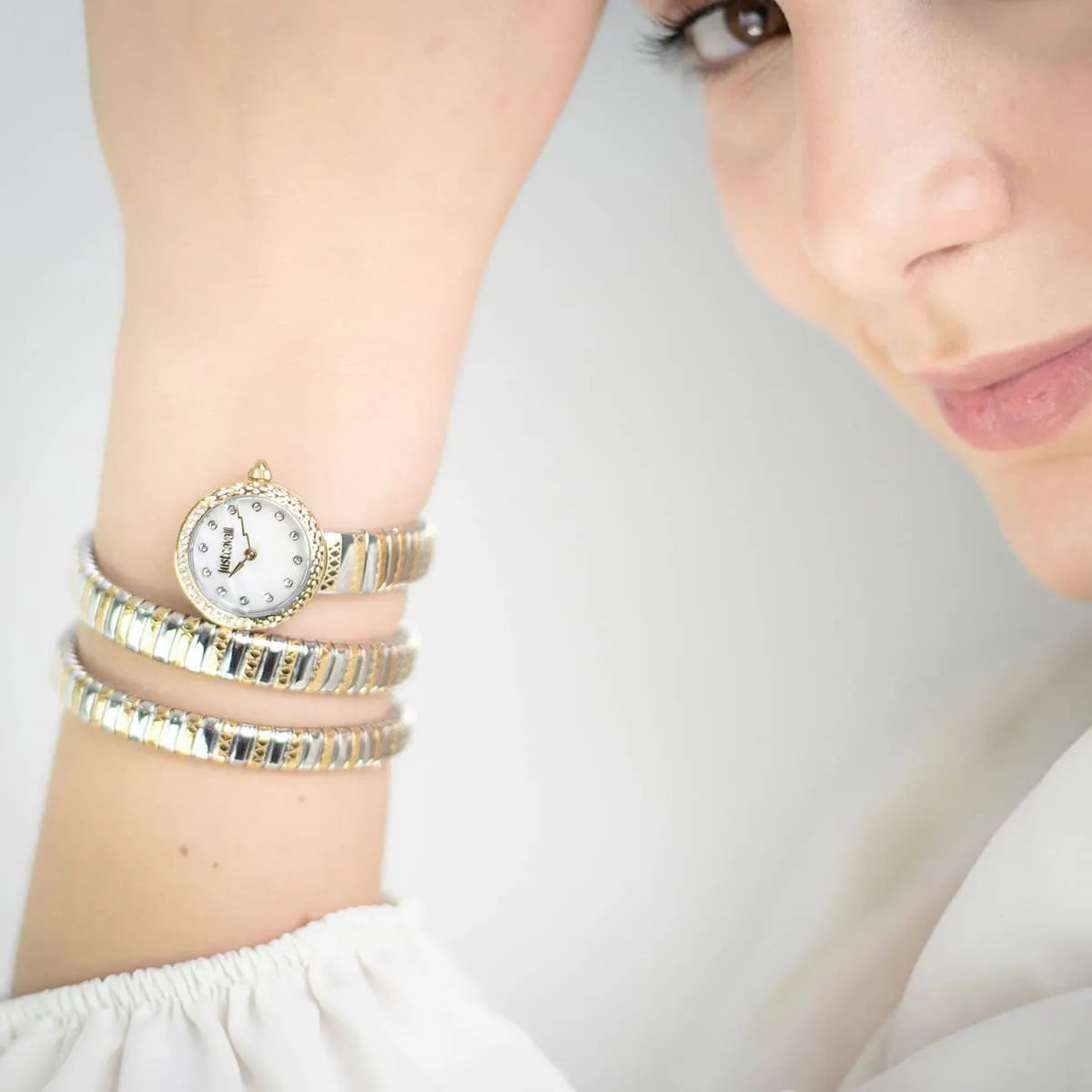 Just Cavalli Signature Snake women's watch worn on wrist showing triple-wrap serpent strap with mother-of-pearl dial