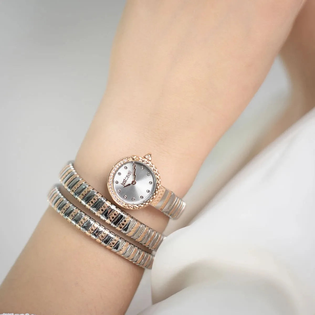 Just Cavalli Enchanting watch worn on wrist showing triple wrap snake strap and white dial