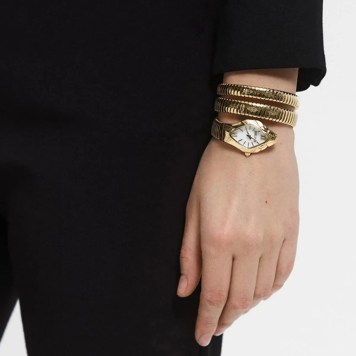 Just Cavalli Cristallo watch worn on wrist with double wrap gold snake bracelet and mother of pearl dial