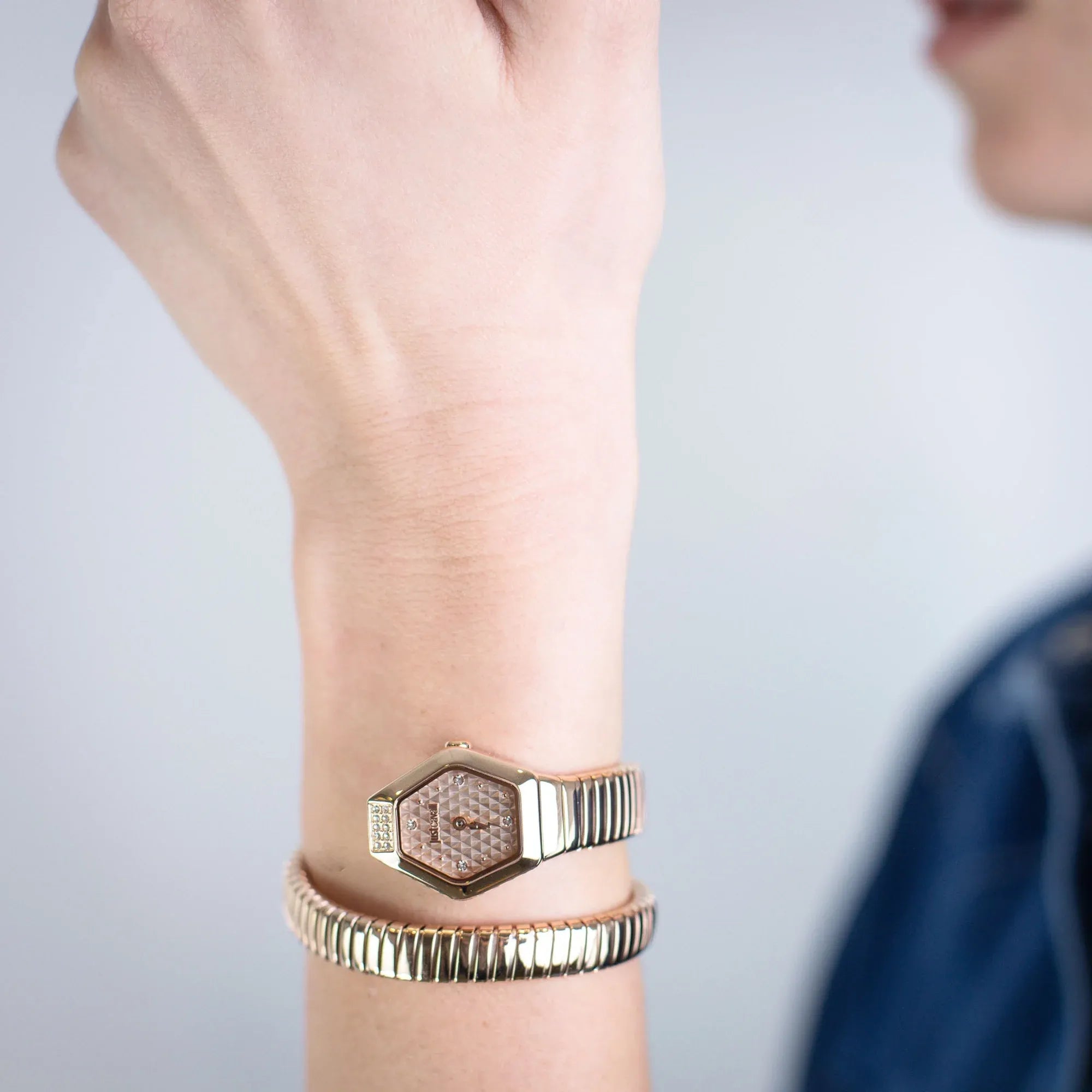 Just Cavalli Signature Snake Splora rose gold watch worn on wrist with matching snake bracelet