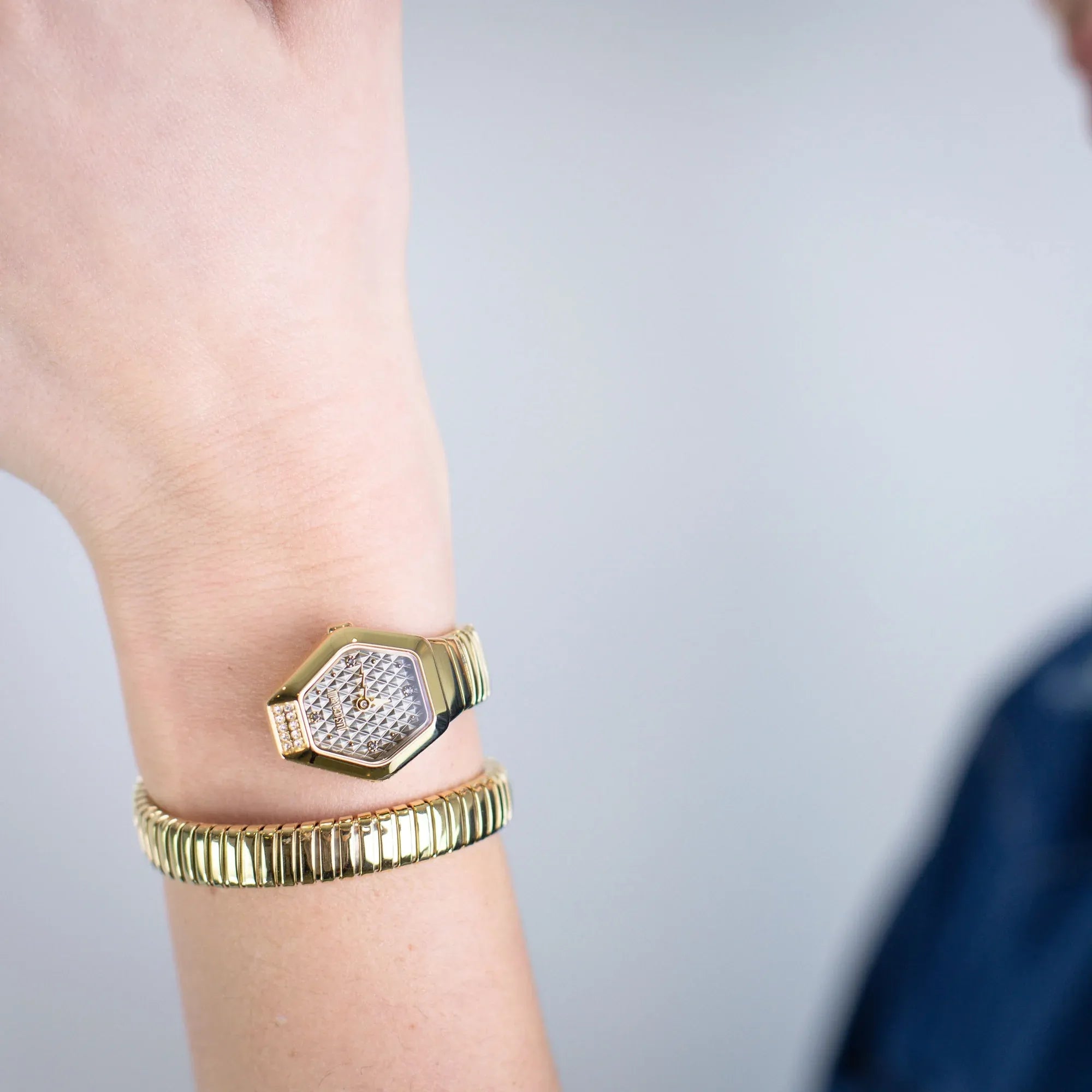 Just Cavalli Signature Snake Splora watch worn on wrist showing two-tone hexagonal case and coiled bracelet design