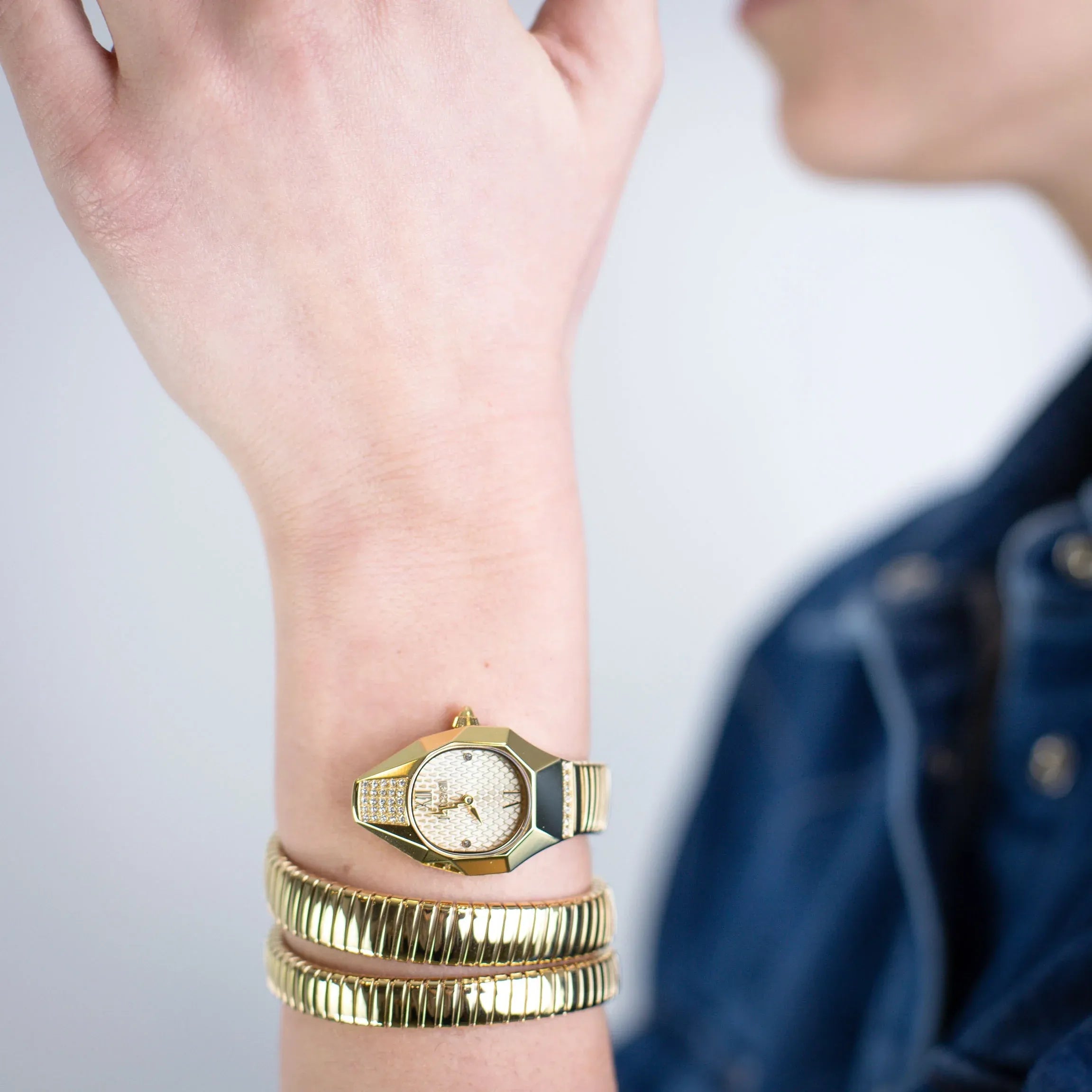 Just Cavalli Signature Snake Lunara watch worn on wrist with gold snake bracelet