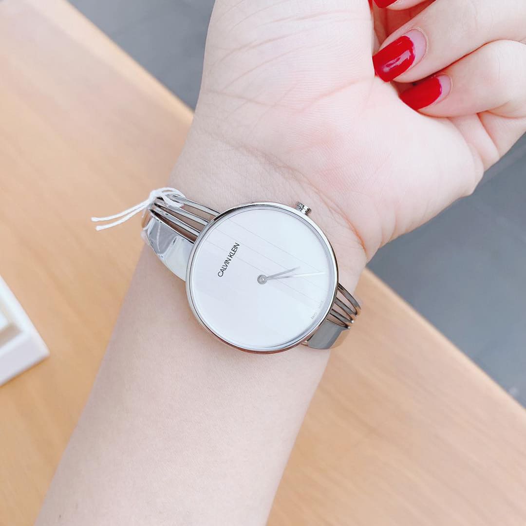 Calvin Klein Cheers watch on wrist showing silver dial and metal bracelet fit
