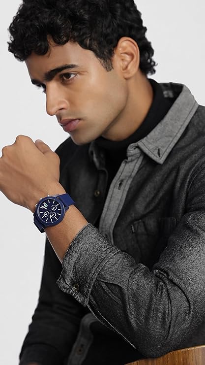 Lacoste 12.12 blue chronograph watch worn on wrist, paired with casual grey jacket