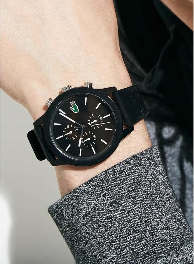Lacoste chronograph watch on wrist showing black dial with chronograph subdials