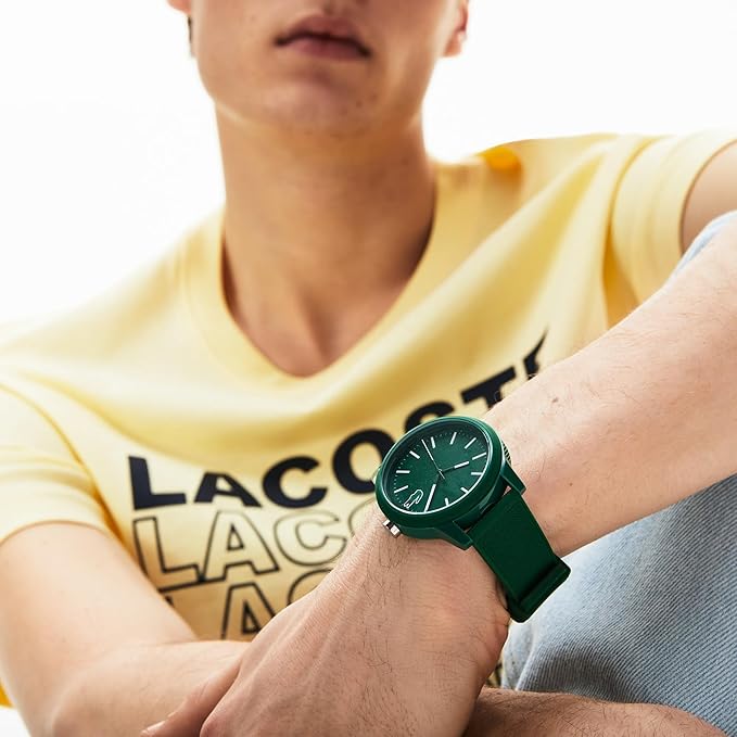 Lacoste green rubber watch worn on wrist displaying dial and strap