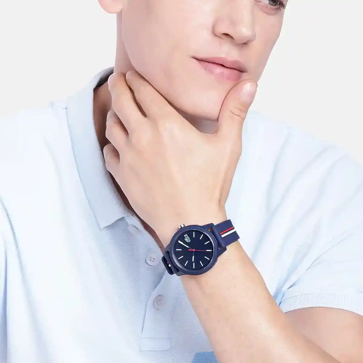 Lacoste 2011070 blue watch worn on wrist, navy strap with color stripe detail