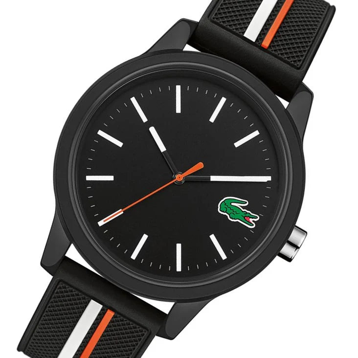 Close-up of Lacoste 2011071 black dial with minimalist white hour markers, orange and white hands, and green crocodile logo