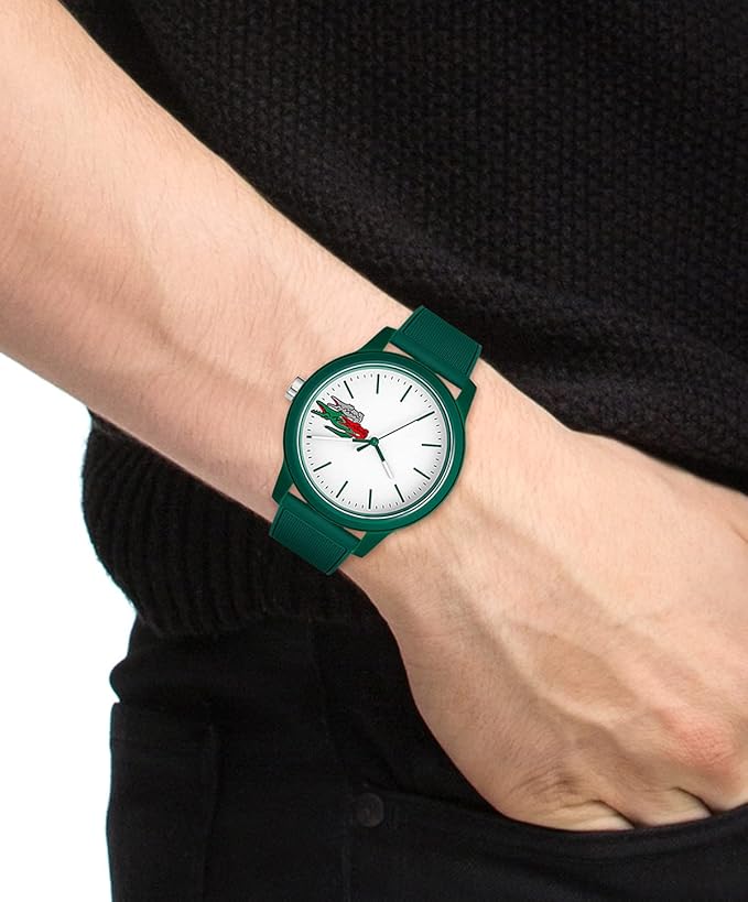Lacoste green watch worn on wrist with white dial and crocodile logo visible