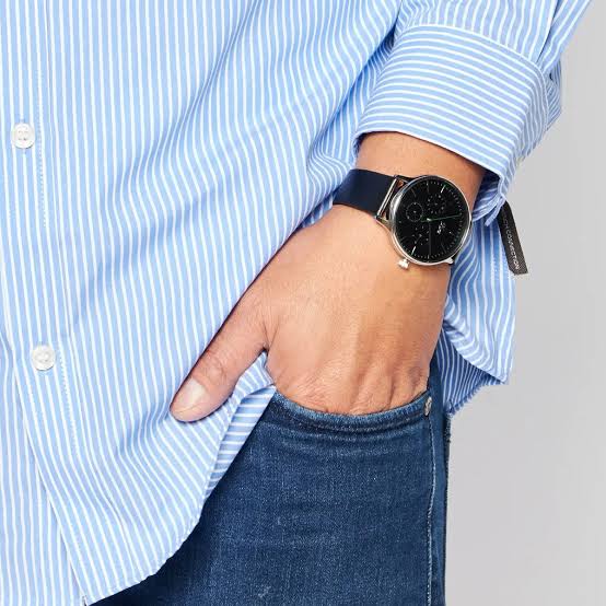 Lacoste multifunction watch worn on wrist with black leather strap