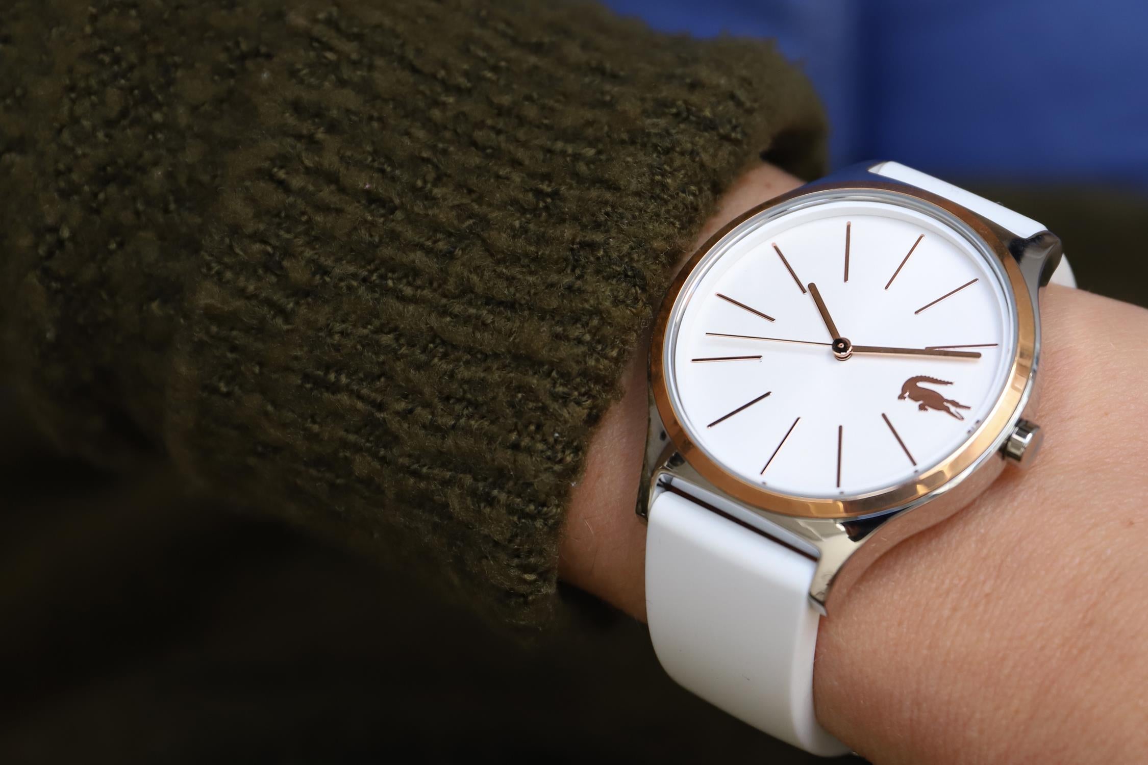 Lacoste Nikita women's watch on wrist showing white silicone strap and minimalist dial