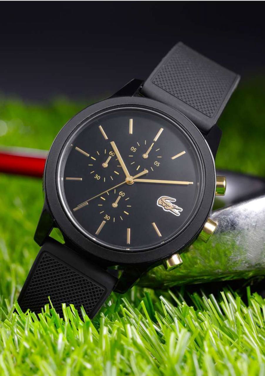 Lacoste TR90 chronograph watch worn on wrist showing black dial with gold accents