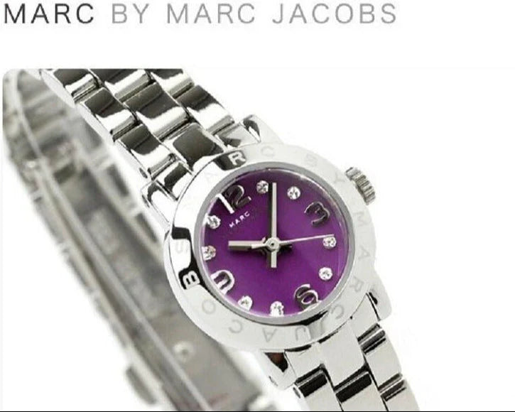 Close-up of purple dial with Arabic numerals and crystal indices on Amy Mini watch