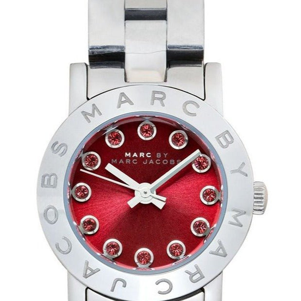 Close-up of Marc Jacobs Amy watch dial with crystal hour markers on red face