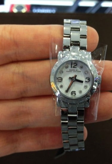Marc Jacobs Amy silver steel women's watch worn on wrist showing dial and bracelet