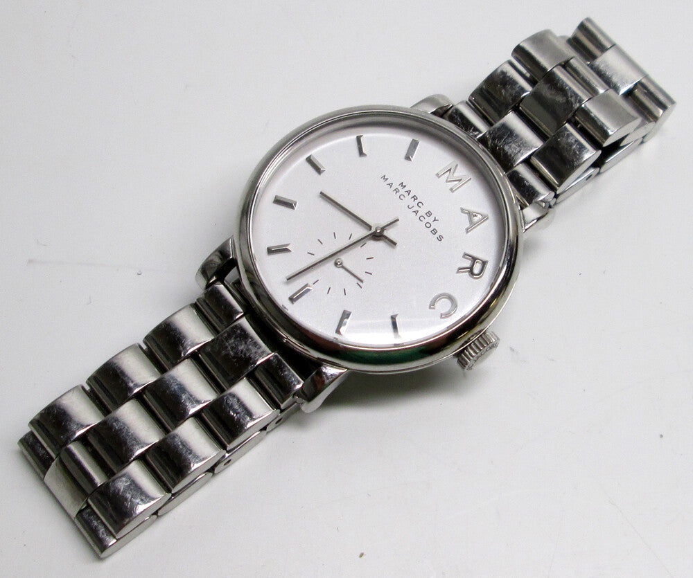 Marc Jacobs Baker white dial watch on wrist with silver metal bracelet