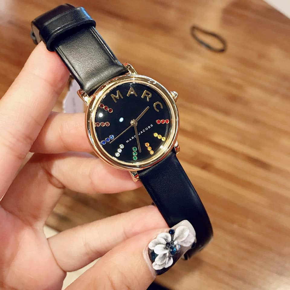 Marc Jacobs Roxy womens watch with gold case and black leather strap detail view