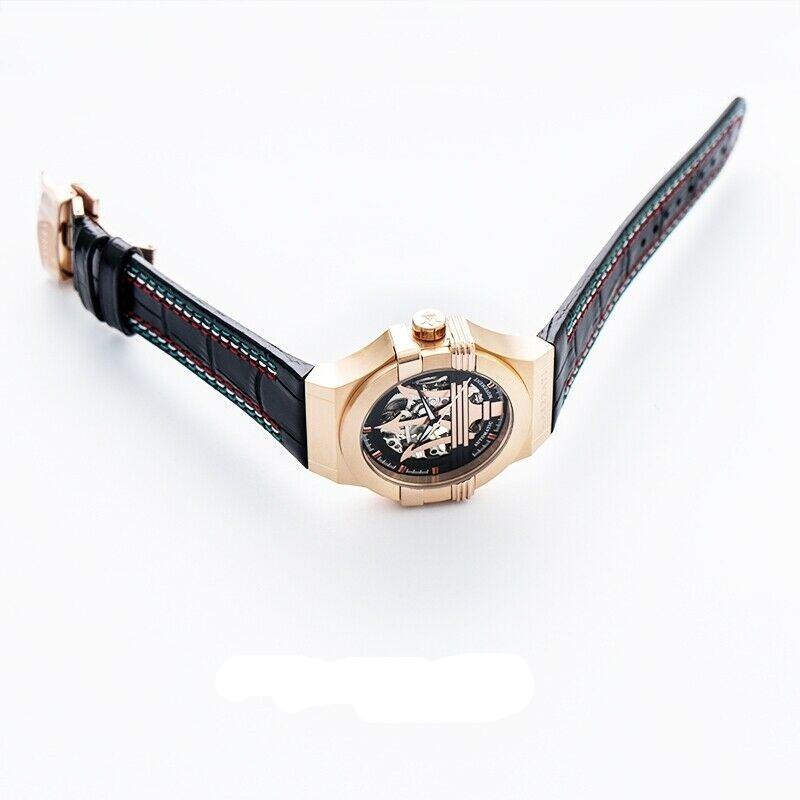Side angle view showing rose gold case profile and black leather strap with red stitching