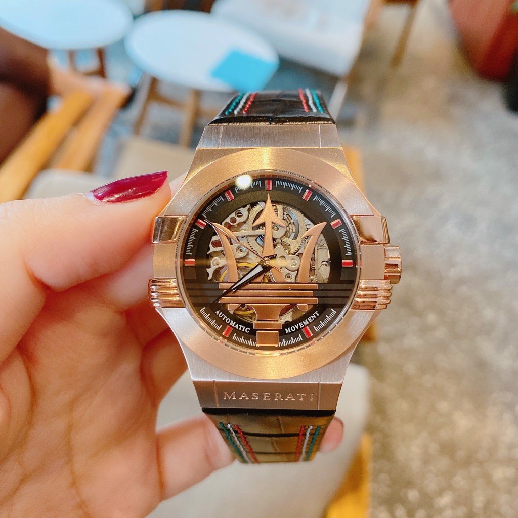 Maserati automatic watch worn on wrist showing rose gold case and black skeleton dial detail