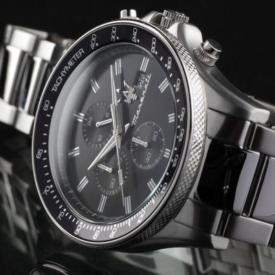 Side profile of Maserati Sfida chronograph showing case depth and lugs with silver bracelet