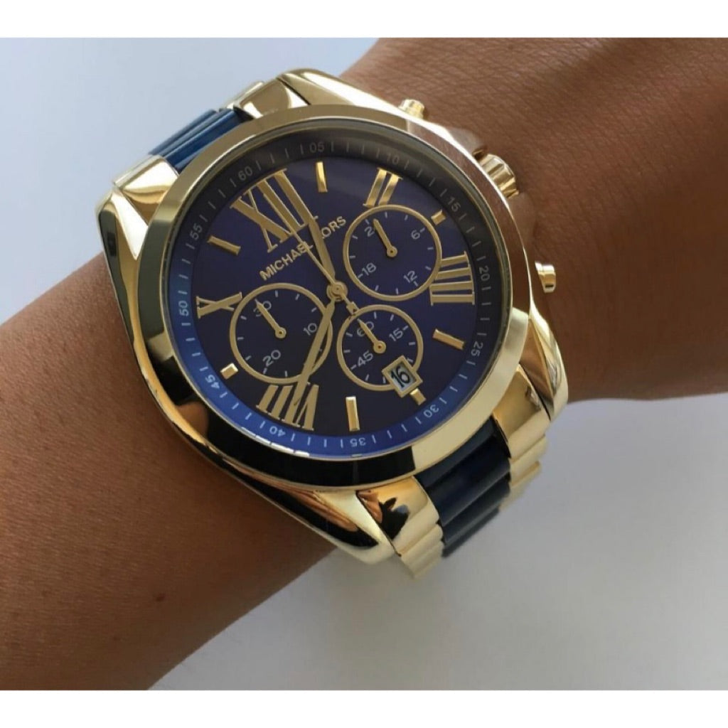 Michael Kors Bradshaw chronograph on wrist showing blue dial and gold bracelet
