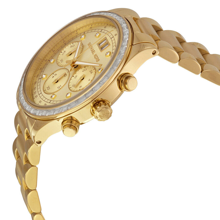 Michael Kors Brinkley watch at angle showing gold case, diamond bezel, chronograph subdials, and bracelet with crown and pushers visible