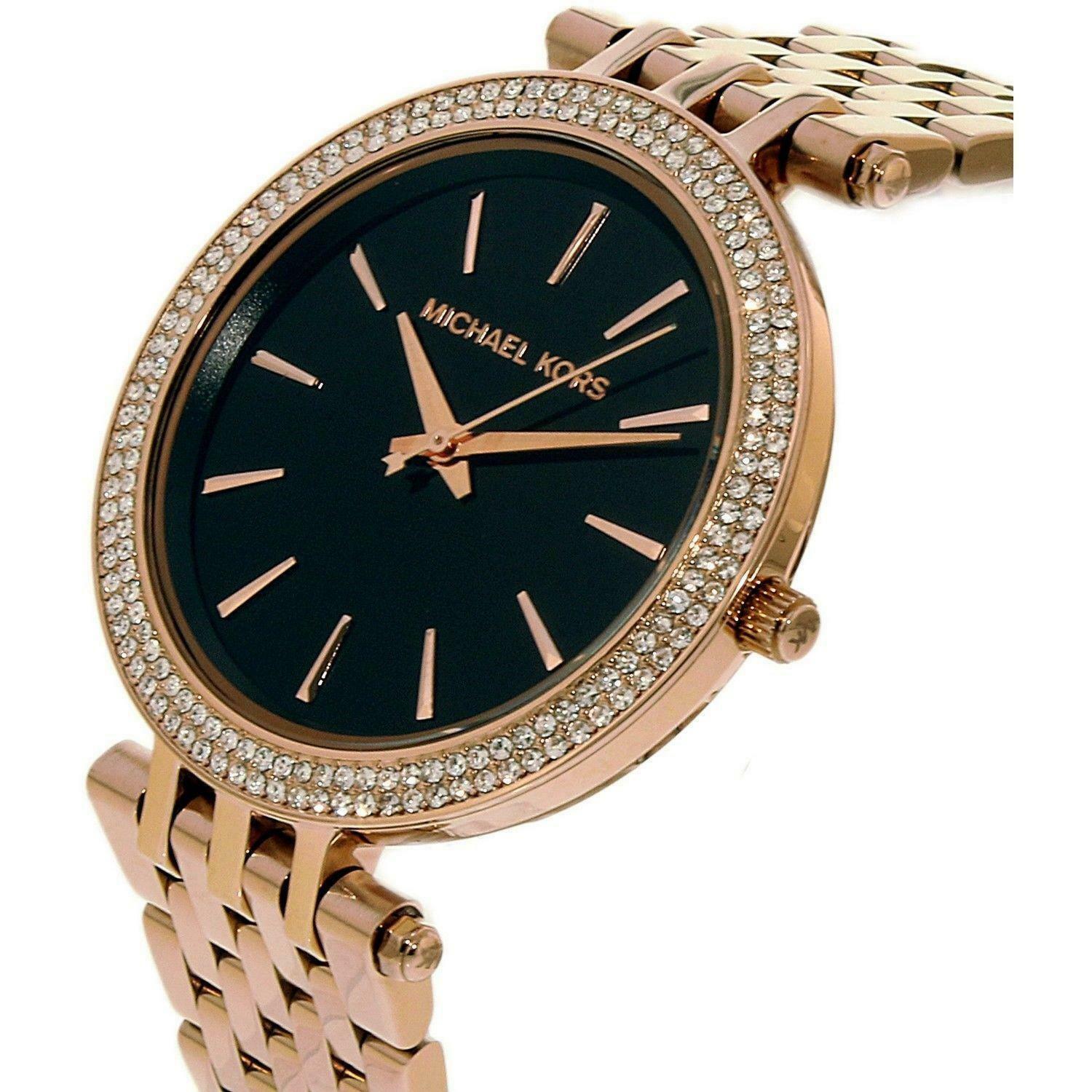 Michael Kors Darci watch at angle displaying black dial with rose gold indices and rose gold bracelet
