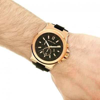 Michael Kors Dylan watch on wrist with rose gold case and black rubber strap