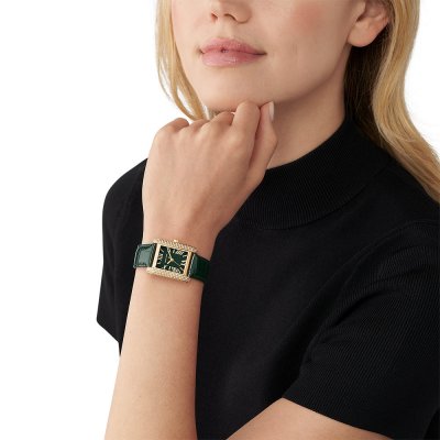 Michael Kors Emery MK4697 watch worn on wrist with green leather strap and gold case