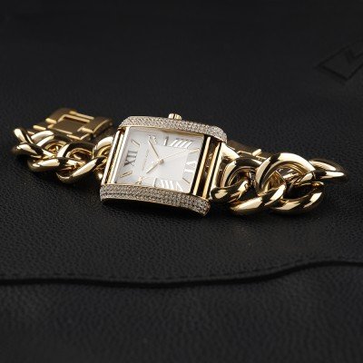 Flat lay of Emery MK7300 watch on black fabric showing full design and chain link band