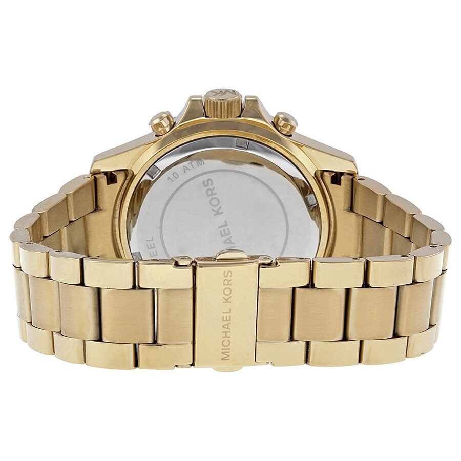 Back case of gold-tone Michael Kors watch with engraved branding