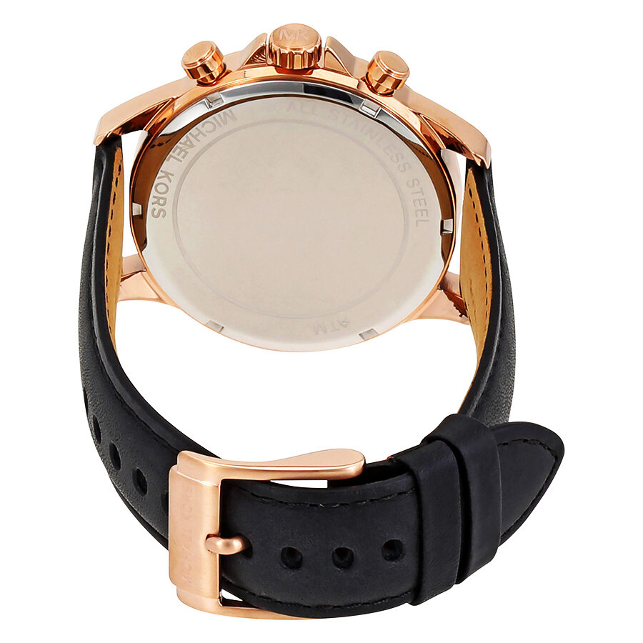 Michael Kors Gage watch caseback showing transparent display and rose gold case with black leather strap