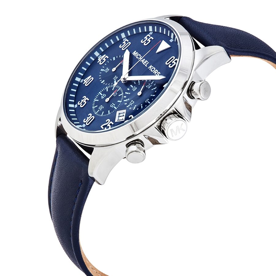 Michael Kors Gage chronograph watch shown at angle with blue dial and navy leather strap