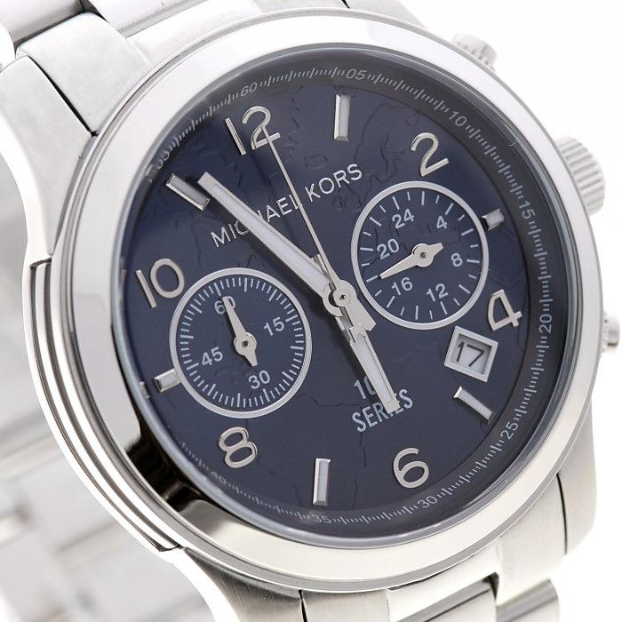 Close-up of blue dial with Arabic numerals, dual chronograph subdials, and date window