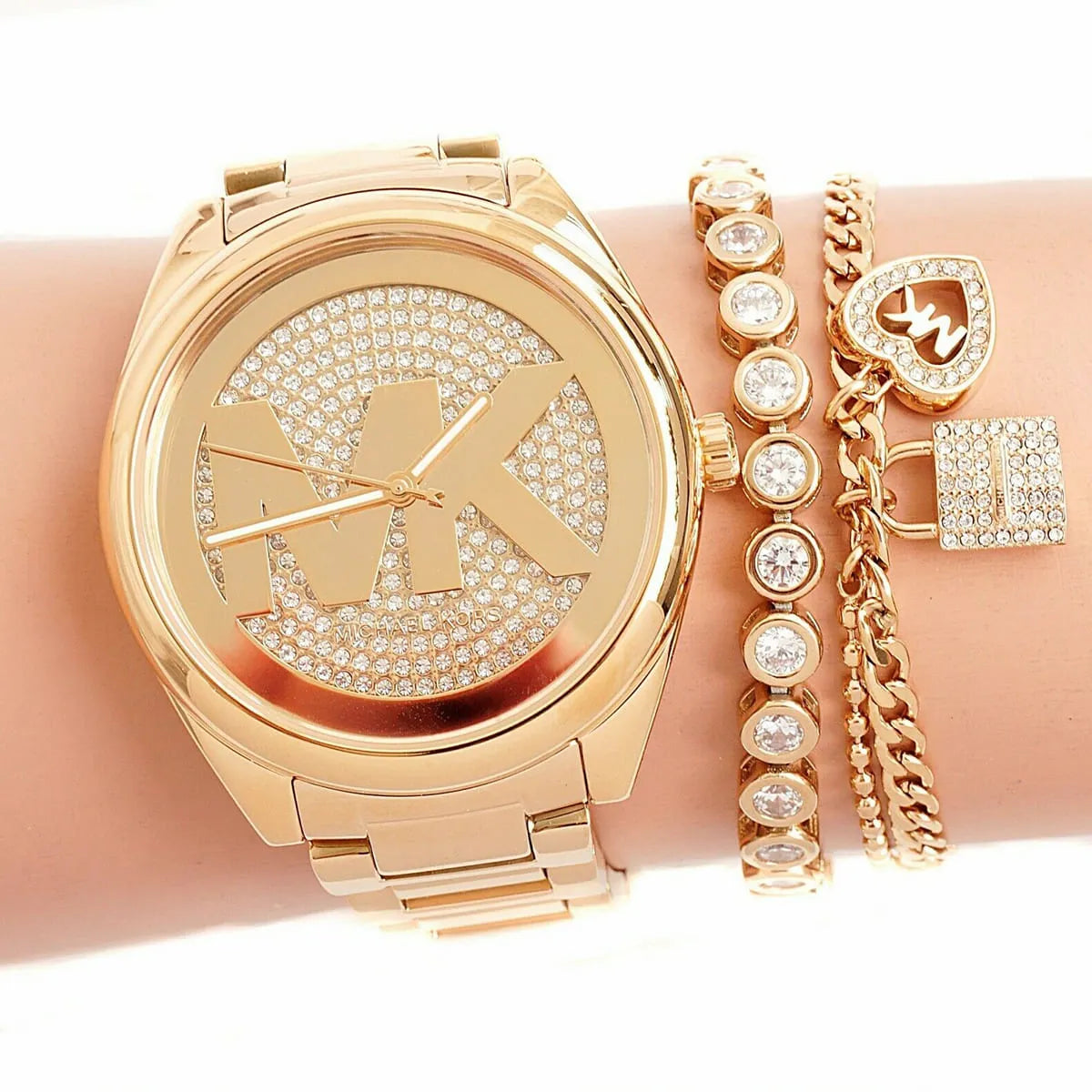 Michael Kors Janelle MK7088 watch on wrist with gold-tone case and crystal-paved dial