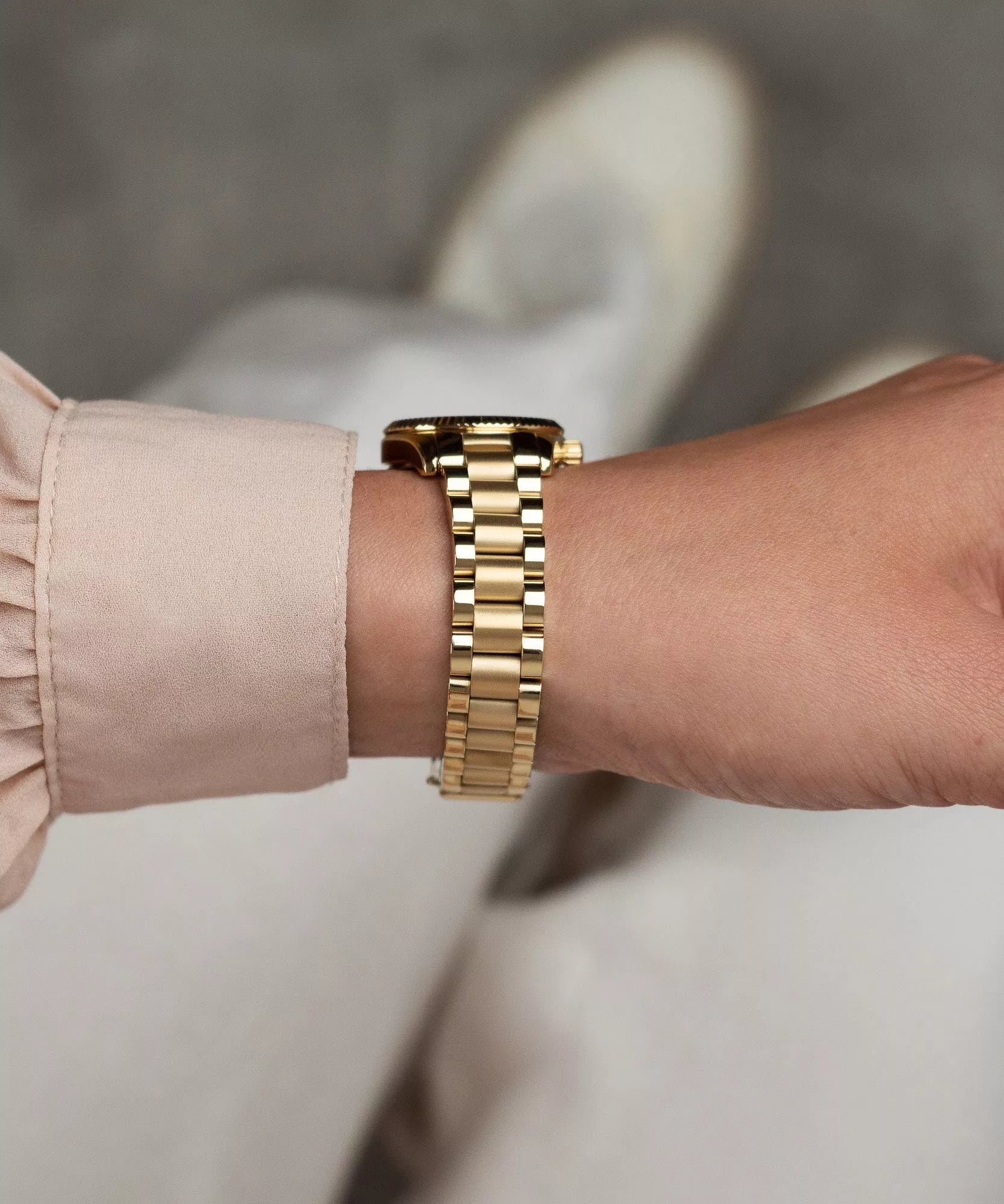 Michael Kors Lexington gold-tone bracelet strap detail on wrist