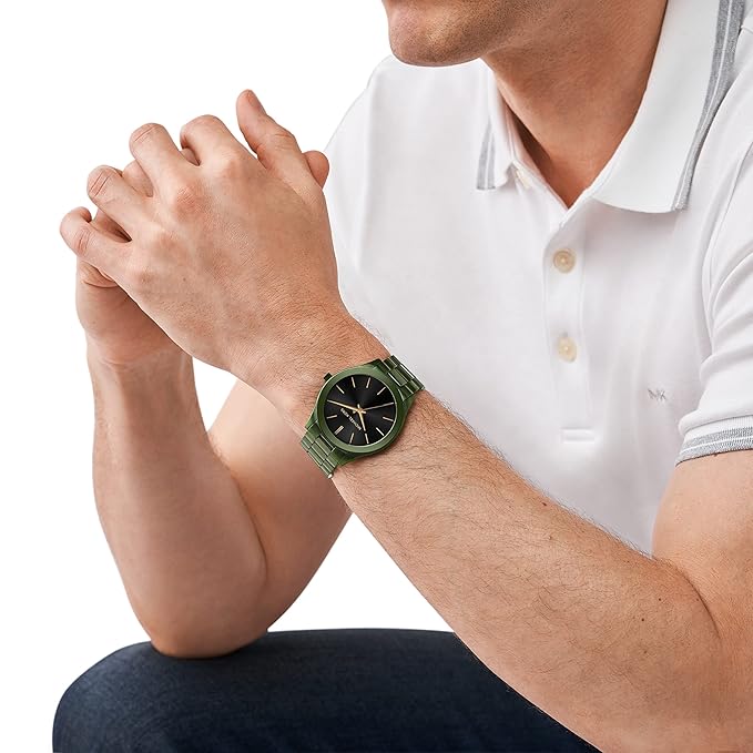 Michael Kors MK8715 men's watch worn on wrist over white polo shirt showing black dial