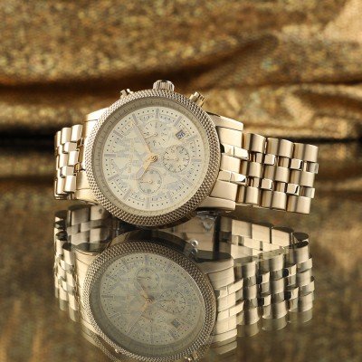 Michael Kors MK8953 Hutton chronograph watch with reflection on gold metallic background
