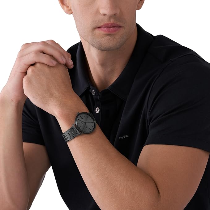 Black men's watch with minimalist dial worn on wrist